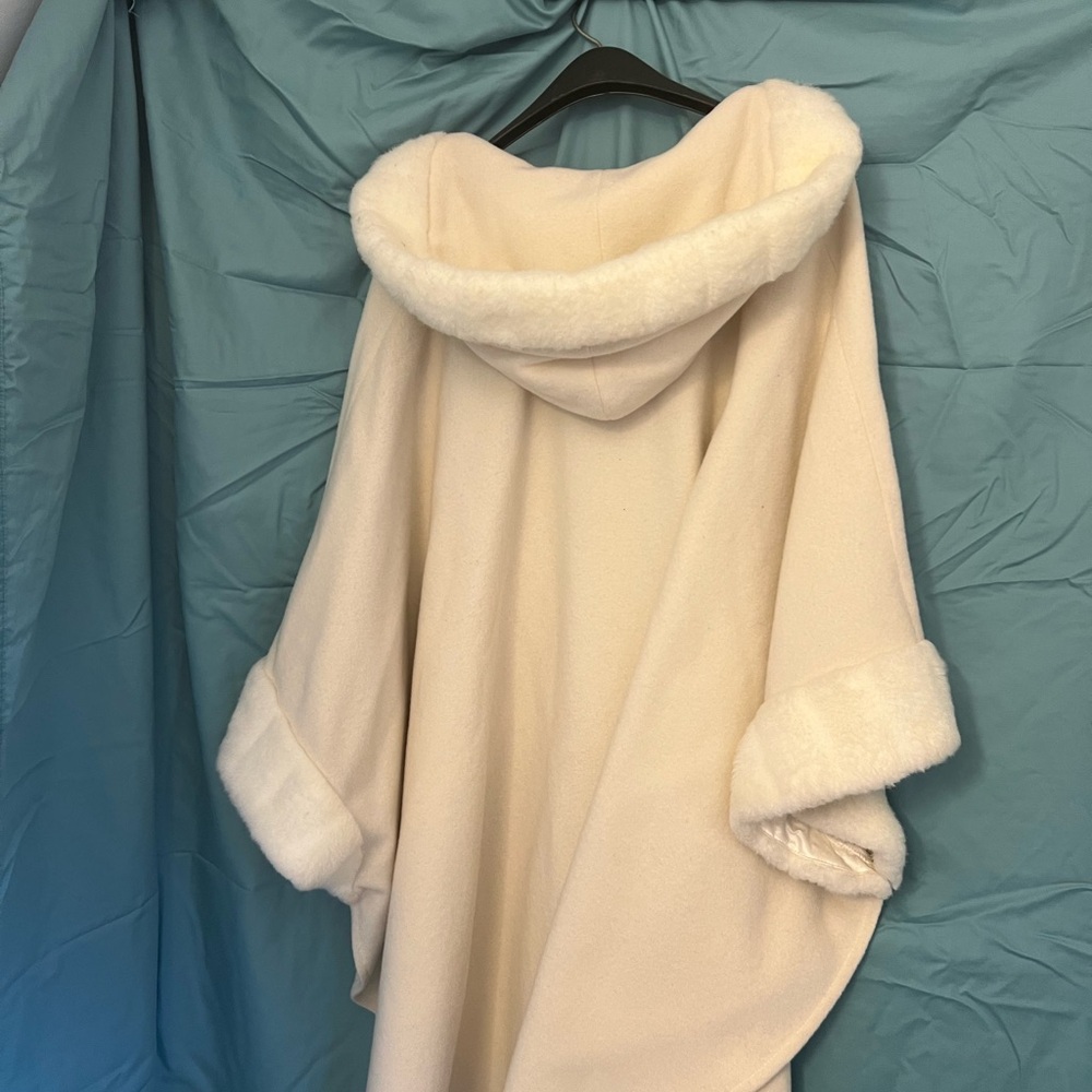 Winter white hooded cape with fur around hood an sleeves relaxed fit